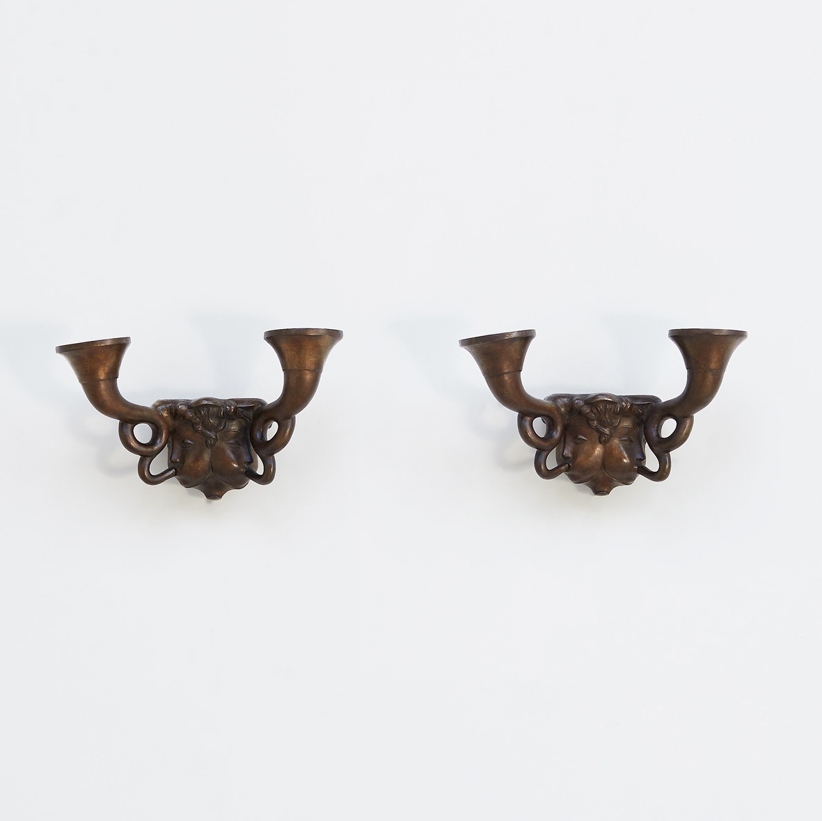 Pair of putti sconces blowing a horn